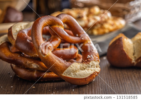 Salted bavarian pretzel on wooden table. 131518585