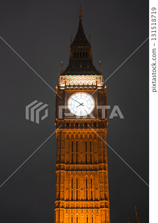 Nighttime view of Elizabeth Tower, also known as Big Ben, in London. The clock face glows brightly, highlighting the tower's intricate architecture. Nighttime view of Elizabeth Tower, also known as Big Ben, in London. The clock face glows brightly, highlighting the tower's intricate architecture. 131518719