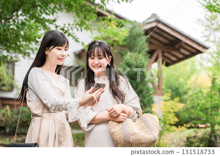 Young Asian woman visiting a tourist spot and searching information on her smartphone (girls' trip, app, travel, sightseeing, gourmet) Young Asian woman visiting a tourist spot and searching information on her smartphone (girls' trip, app, travel, sightseeing, gourmet) 131518733