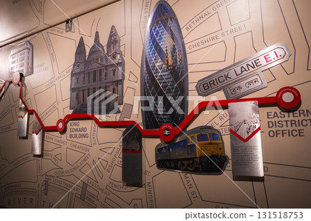 A wall display shows a stylized map of London with landmarks like St. Paul's Cathedral and the Gherkin, transit routes, and East London street names. A wall display shows a stylized map of London with landmarks like St. Paul's Cathedral and the Gherkin, transit routes, and East London street names. 131518753