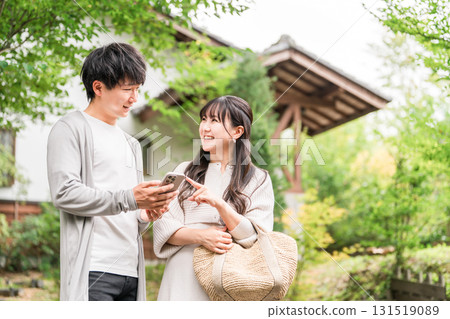 Young Asian couple visiting a tourist spot and searching information on their smartphone (apps, travel, tourism, gourmet) Young Asian couple visiting a tourist spot and searching information on their smartphone (apps, travel, tourism, gourmet) 131519089
