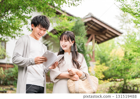 A young couple looking for a destination while looking at a guidebook on their trip 131519488