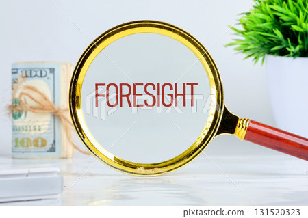 FORESIGHT text showed through a magnifying glass on a light background. Planning and analytics concept. FORESIGHT text showed through a magnifying glass on a light background. Planning and analytics concept. 131520323