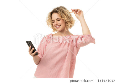 Woman joyfully interacts with her phone, isolated on white, PNG 131521052