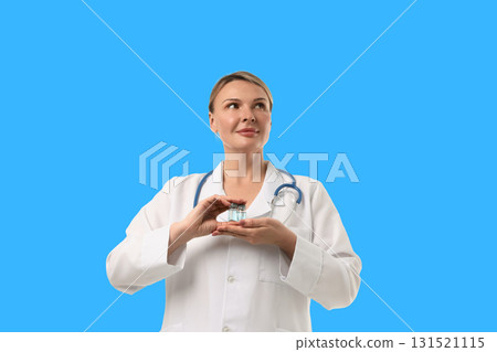 Health expert holds vaccine vials in a clinical setting Health expert holds vaccine vials in a clinical setting 131521115