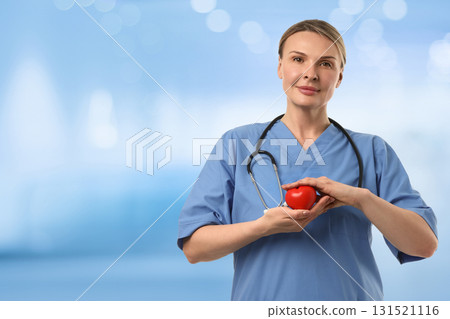 Medical staff displays heart symbol in healthcare setting Medical staff displays heart symbol in healthcare setting 131521116