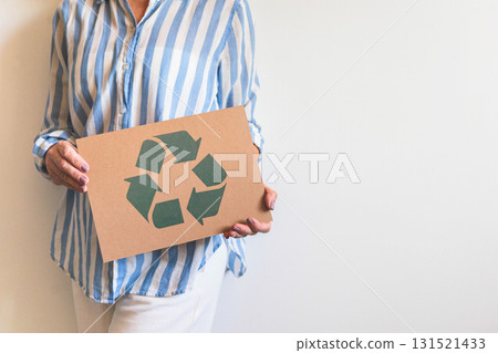 Casual mature female hands holding recycling reusing zero waste signboard banner copy space Casual mature female hands holding recycling reusing zero waste signboard banner copy space 131521433
