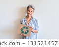 Mature gray haired woman with recycling reusing zero waste signboard isolated on white background 131521457