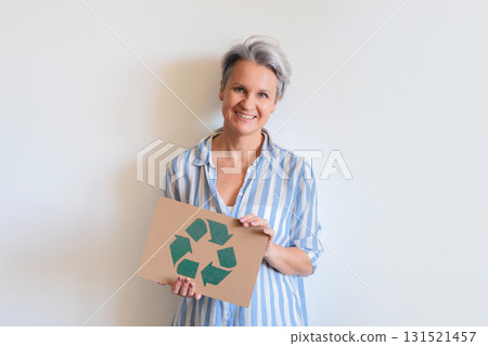 Mature gray haired woman with recycling reusing zero waste signboard isolated on white background Mature gray haired woman with recycling reusing zero waste signboard isolated on white background 131521457