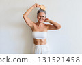 Beautiful gray haired mature woman making hairstyle haircomb posing isolated on white background 131521458