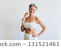 Beautiful gray haired mature woman making hairstyle haircomb posing isolated on white background 131521461