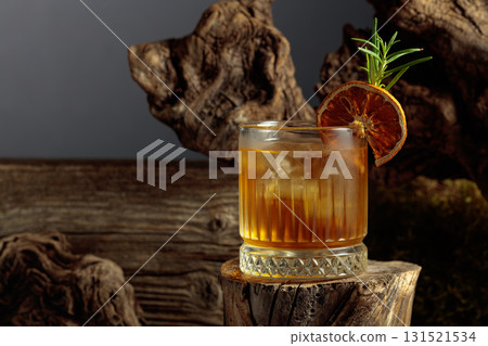 Old-fashioned cocktail with ice on an old wooden stump. Old-fashioned cocktail with ice on an old wooden stump. 131521534