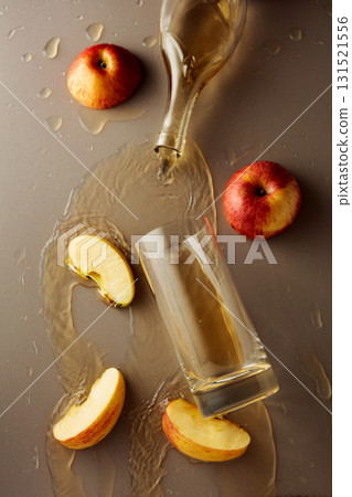 Apple juice is poured into a glass. Apple juice is poured into a glass. 131521556