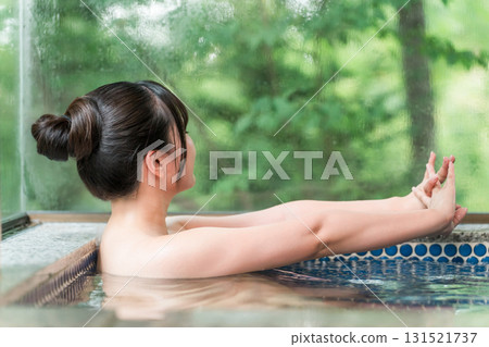 A woman bathing in a hot spring bath at a hot spring inn or private bath 131521737