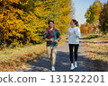 Sporty family couple morning jogging in city autumn beautiful park. Young active man 131522201