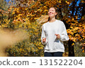Young beautiful girl jogging in city beautiful autumn park and forest enjoy outdoor sports.  131522204