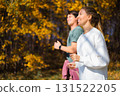 Young beautiful couple jogging in city beautiful autumn park and forest, enjoying outdoor sports 131522205