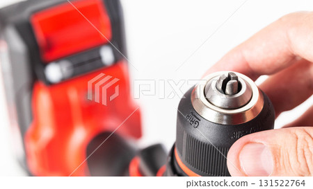 Adjusting the screwing power in a modern drill screwdriver, close-up, industry Adjusting the screwing power in a modern drill screwdriver, close-up, industry 131522764