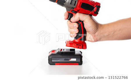 Replacing the battery in a new drill screwdriver on a white background, battery charge and capacity, close-up. Copy space for text Replacing the battery in a new drill screwdriver on a white background, battery charge and capacity, close-up. Copy space for text 131522766