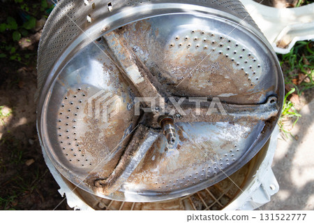 Breakage of the metal cross in the washing machine and non-separable drum. Fault in washing machines, close-up Breakage of the metal cross in the washing machine and non-separable drum. Fault in washing machines, close-up 131522777