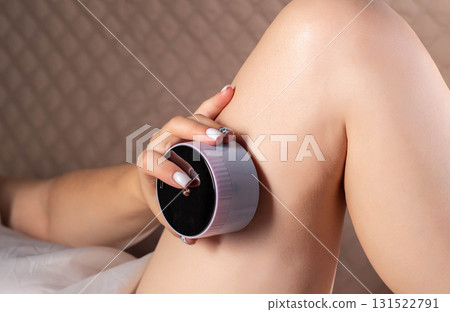 The girl does an anti-cellulite massage on her legs with a portable vacuum massager. Getting rid of flabby skin and cellulite, close-up, effective. Copy space for text The girl does an anti-cellulite massage on her legs with a portable vacuum massager. Getting rid of flabby skin and cellulite, close-up, effective. Copy space for text 131522791