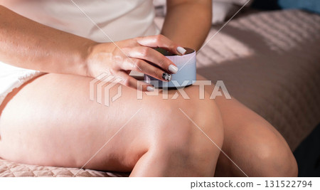 The girl does an anti-cellulite massage on her legs with a portable vacuum massager. Getting rid of flabby skin and cellulite, close-up, effective The girl does an anti-cellulite massage on her legs with a portable vacuum massager. Getting rid of flabby skin and cellulite, close-up, effective 131522794