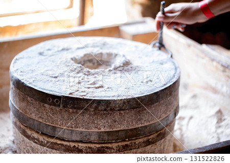 Old millstones for breaking grain into flour, antique, close-up Old millstones for breaking grain into flour, antique, close-up 131522826