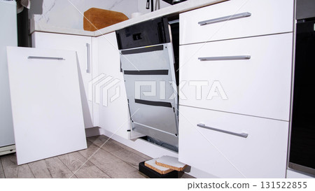 Installing a white kitchen cabinet on a new dishwasher. Copy space for text Installing a white kitchen cabinet on a new dishwasher. Copy space for text 131522855