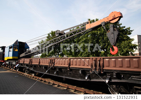 Vintage crane train used in construction stands prominently in an outdoor museum setting 131522931
