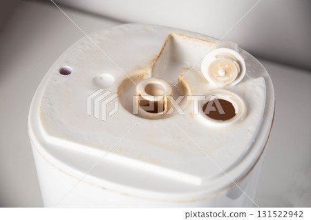 Unpleasant smell, rust and scale from water in the humidifier, white background, close-up 131522942