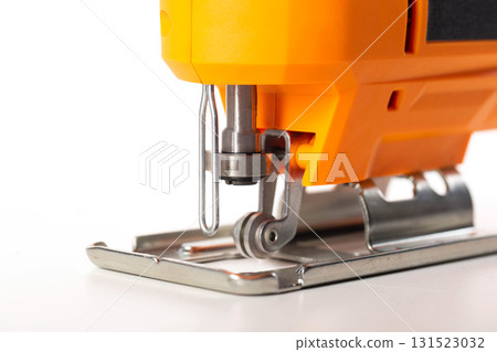 A modern, new electric hand-held jigsaw on a white background, isolated. Power tool for woodworking, close-up A modern, new electric hand-held jigsaw on a white background, isolated. Power tool for woodworking, close-up 131523032