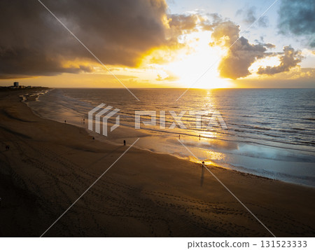 A Stunning Sunset Over a Tranquil Beach with Gentle Waves Captivates All Who Are Present A Stunning Sunset Over a Tranquil Beach with Gentle Waves Captivates All Who Are Present 131523333