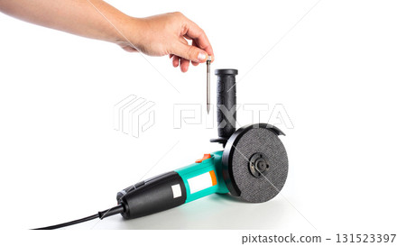 Modern angle grinder on a white background, isolated, with a metal pencil in an additional handle, close-up. Copy space for text 131523397