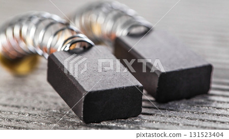 Electric motor brushes on gray background, macro, industry 131523404