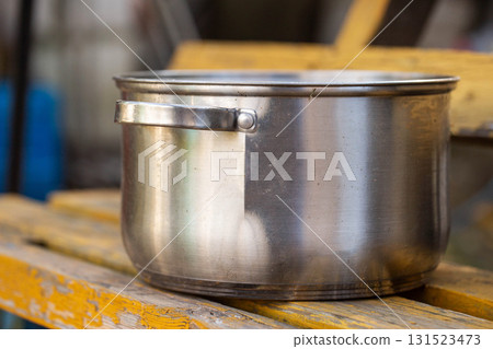 A broken metal pan with a crack, close-up 131523473