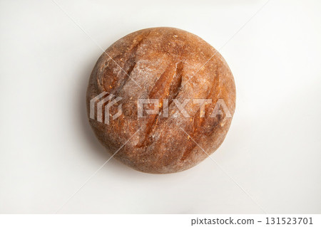 Freshly baked round bread resting on a clean surface in kitchen setting 131523701