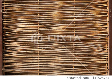 Unique wooden fence design with interwoven branches and twigs for rustic charm Unique wooden fence design with interwoven branches and twigs for rustic charm 131523787