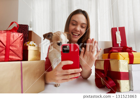 Joyful and Festive Celebration with a Adorable Dog and a Variety of Gifts for Everyone 131523863