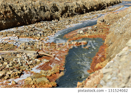 Toxic mine water discharge, acid mine drainage contaminates the environment 131524082
