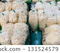 Fresh Enoki Mushrooms in Market Display. 131524579