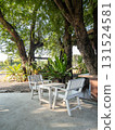 Shady Tree Cafe Patio with White Wooden Furniture. 131524581