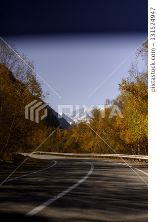 A high-mountain settlement at the foot of a rugged cliff with terracotta slopes A high-mountain settlement at the foot of a rugged cliff with terracotta slopes 131524947
