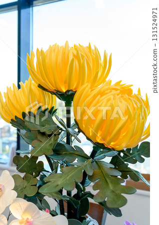 bright yellow foamiran chrysanthemums with green leaves bright yellow foamiran chrysanthemums with green leaves 131524971