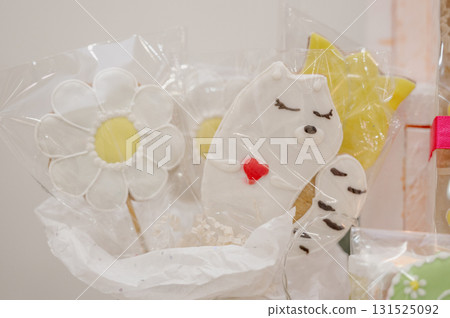 Close-up of edible cookie-shaped souvenirs in a gift bag, ready for sale. Close-up of edible cookie-shaped souvenirs in a gift bag, ready for sale. 131525092