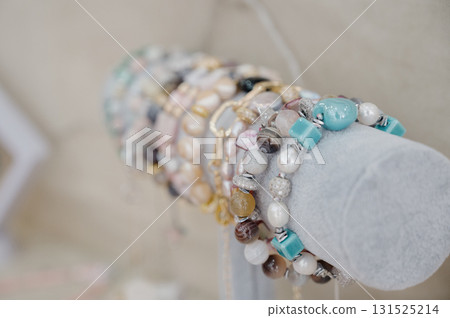 Close-up of handmade bracelets made of agate, pearls and rhinestones Close-up of handmade bracelets made of agate, pearls and rhinestones 131525214