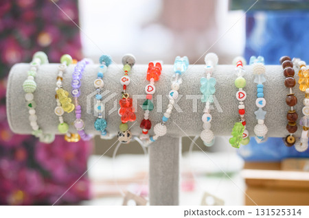 Handmade jewelry: bracelets with resin bears and bright beads at the fair 131525314