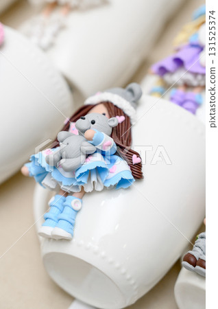 White mugs decorated with polymer clay fairy tale characters 131525374