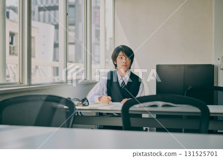 A male student studying with a serious expression A male student studying with a serious expression 131525701