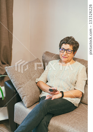 Senior woman watching TV 131526226