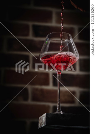 Pouring red wine 131526260
